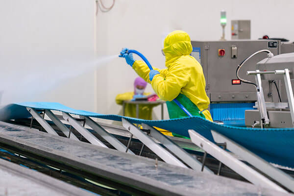 Worker using high-pressure water spray