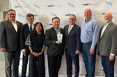 Highland Bridge green stormwater infrastructure system project partners pose for a photo in recognition of a 2025 Project Excellence Award from the Water Environment Federation (WEF).