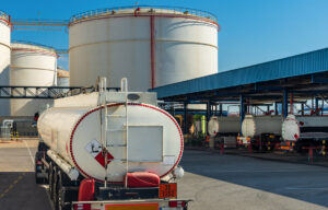A fuel tanker truck waiting to load at a loading dock.