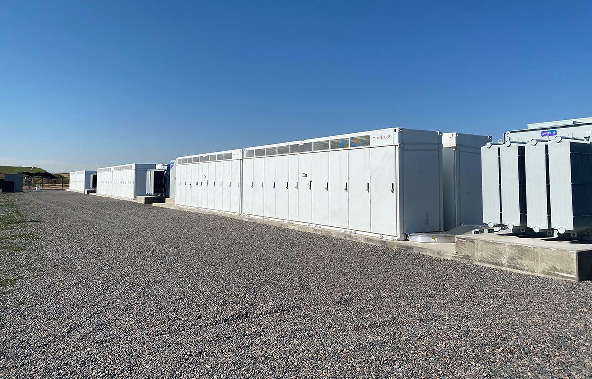 Rows of Tesla Megapack batteries and transformers installed on concrete foundations at a United Power substation—one of eight new BESS units installed across United Power’s service area.
