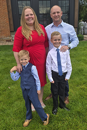 Darcy, her husband, and their two children attend a wedding together.