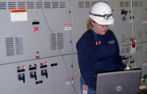 Darcy Tenan on site, commissioning the new relays for a 480V relay upgrade project. This project delivered engineering design, drawings, and relay settings to upgrade the existing electromechanical relays with new microprocessor relays.
