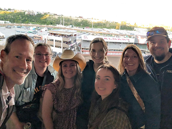 Shaye and her Barr colleagues pose for a group photo with the Calgary Stampede in the background.