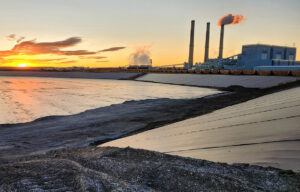 A major coal-fired power plant at sunset.