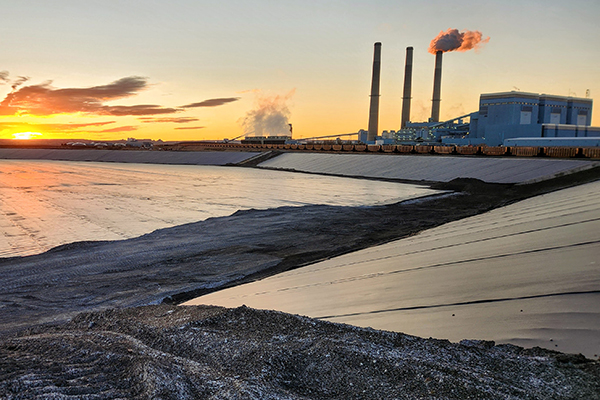 A major coal-fired power plant at sunset.