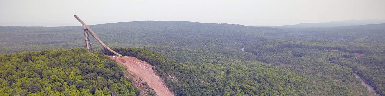 The Copper Peak ski jump superstructure and landing hill on a forested hillside near Ironwood, Michigan