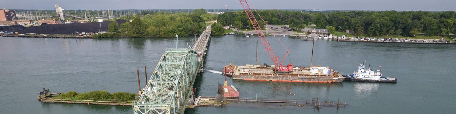 Temporary dock and flow deflector placed in river for bridge repairs.