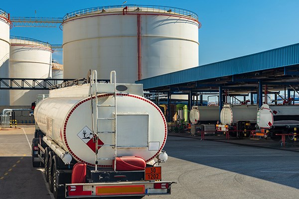 Fuel tanker truck waiting to load at a loading dock.
